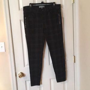 Black plaid skinny jeans w/zipper pocket detail.
